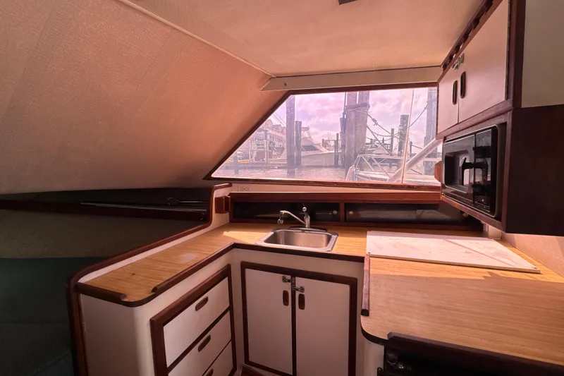 Slide: The Image of Interior of 1985 Blackfin 32 Flybridge boat with kitchenette and window view. - 31