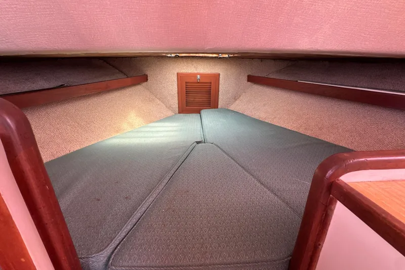 Slide: The Image of Interior cabin of 1985 Blackfin 32 Flybridge boat with cushioned sleeping area. - 32