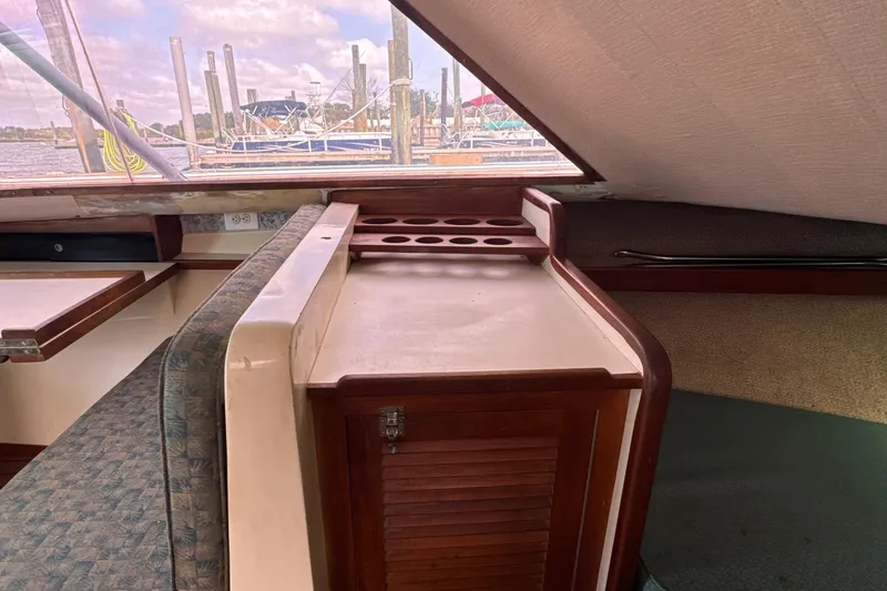Slide: The Image of Interior of 1985 Blackfin 32 Flybridge boat with wooden cabinetry and marina view. - 33