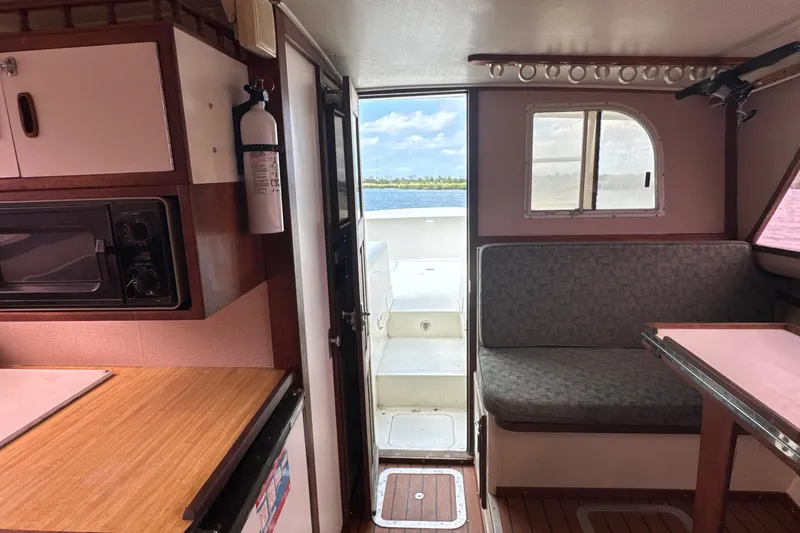 Slide: The Image of Interior of 1985 Blackfin 32 Flybridge boat with kitchenette and seating area. - 36