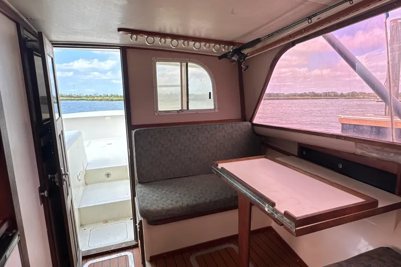 Slide: The Image of Interior of 1985 Blackfin 32 Flybridge boat with seating and table, overlooking water. - 37