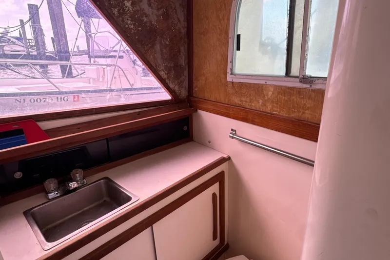 Slide: The Image of Interior of 1985 Blackfin 32 Flybridge boat with sink and window view. - 39