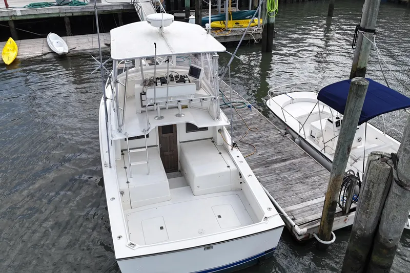 Slide: The Image of 1985 Blackfin 32 Flybridge boat docked at marina, aerial view. - 4