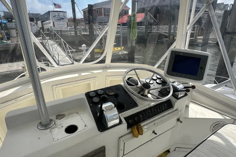 Slide: The Image of 1985 Blackfin 32 Flybridge helm with steering wheel and navigation equipment at dock. - 41