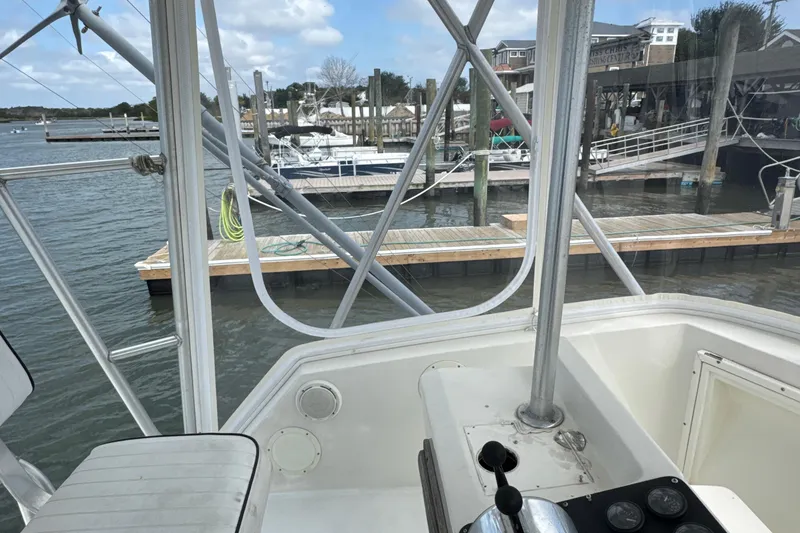 Slide: The Image of 1985 Blackfin 32 Flybridge boat docked at marina, view from helm station. - 42