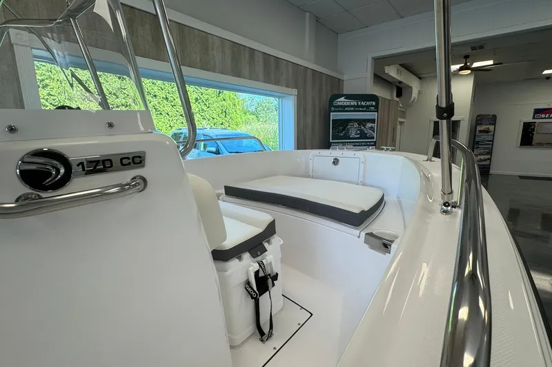 Slide: The Image of 2025 Edgewater 170CC boat interior with seating, displayed in a showroom. - 14