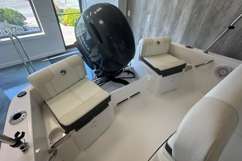 Slide: The Image of 2025 Edgewater 170CC boat interior with Yamaha engine, featuring white cushioned seating. - 6