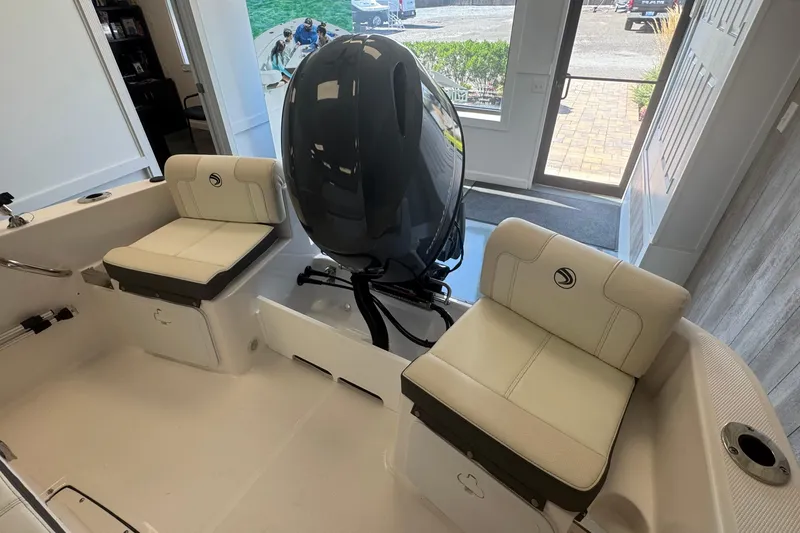 Slide: The Image of 2025 Edgewater 170CC boat interior with dual seats and outboard motor. - 8