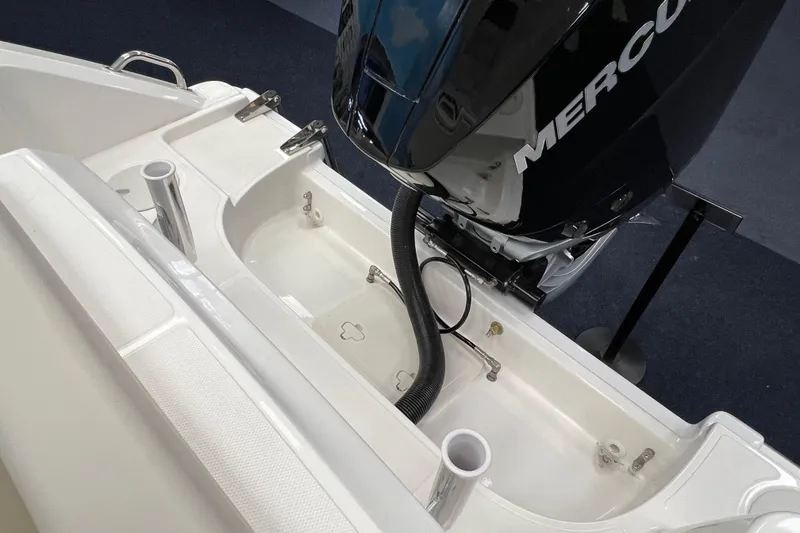 Slide: The Image of 2024 Boston Whaler 230 Outrage boat with Mercury engine, featuring a sleek white interior design. - 10