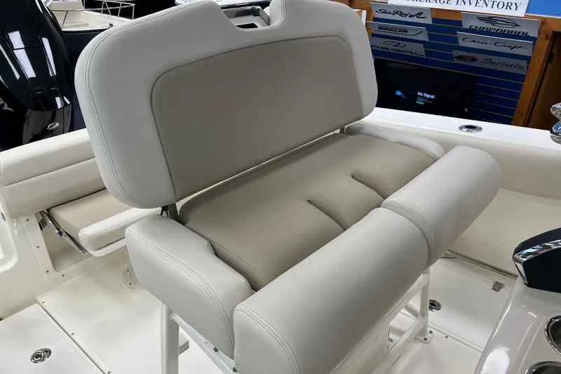 Slide: The Image of 2024 Boston Whaler 230 Outrage boat seat, featuring plush beige upholstery. - 15