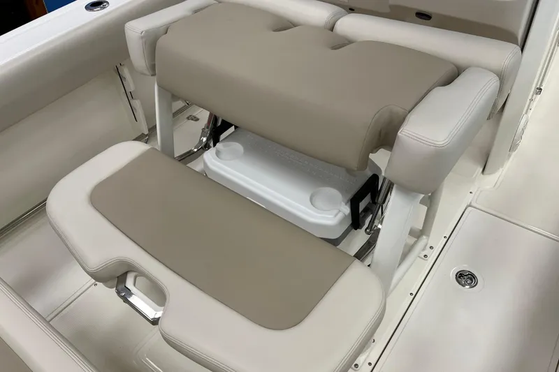 Slide: The Image of 2024 Boston Whaler 230 Outrage boat seating with integrated cooler storage. - 16