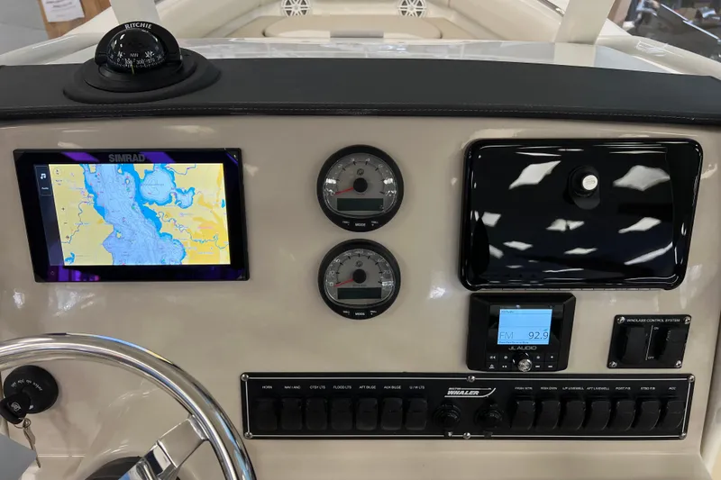 Slide: The Image of 2024 Boston Whaler 230 Outrage dashboard with navigation and control systems. - 18