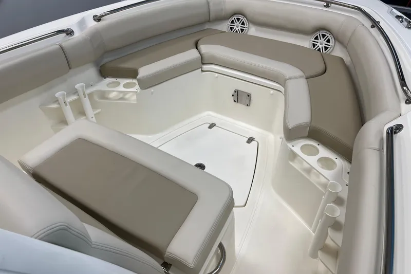 Slide: The Image of 2024 Boston Whaler 230 Outrage interior with cushioned seating and cup holders. - 20