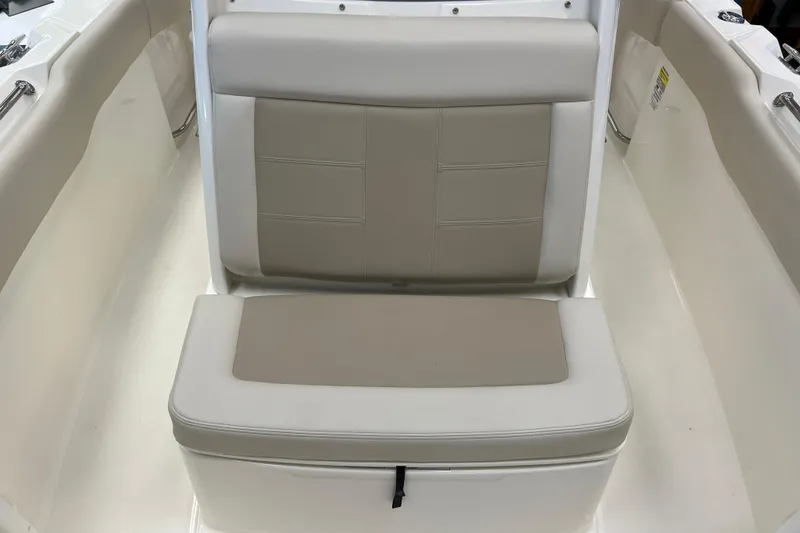 Slide: The Image of 2024 Boston Whaler 230 Outrage boat seat, beige and white upholstery, interior view. - 21