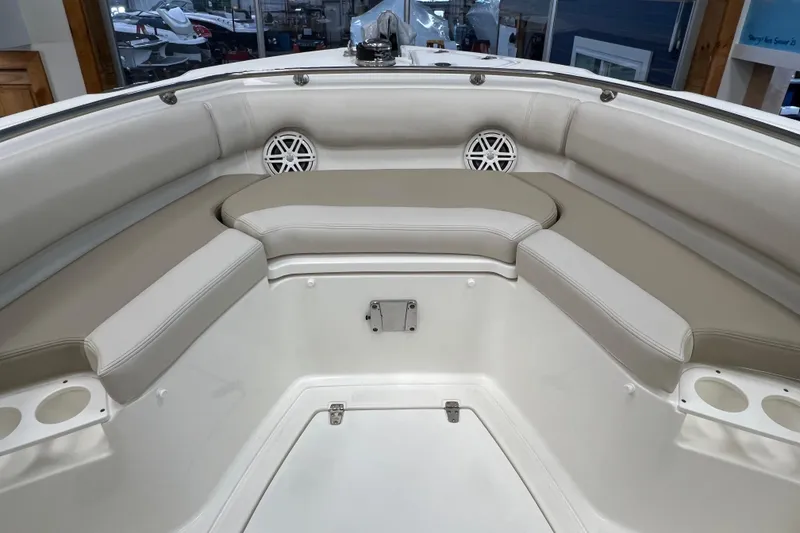 Slide: The Image of 2024 Boston Whaler 230 Outrage boat interior with cushioned seating and cup holders. - 23