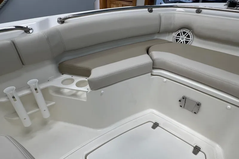 Slide: The Image of 2024 Boston Whaler 230 Outrage interior with cushioned seating and cup holders. - 24