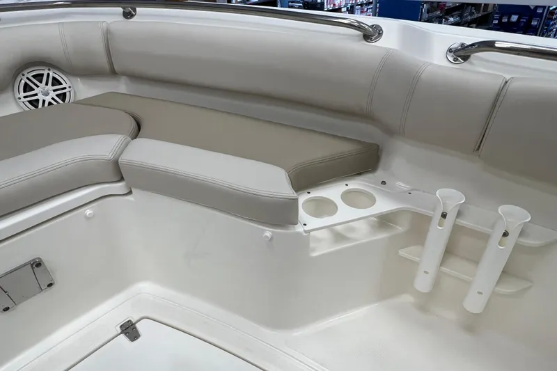 Slide: The Image of 2024 Boston Whaler 230 Outrage interior with cushioned seating and cup holders. - 25