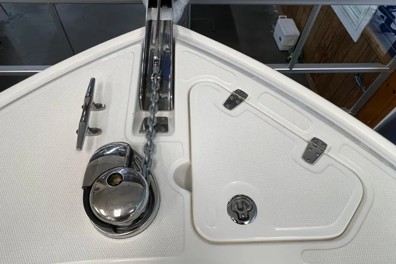 Slide: The Image of 2024 Boston Whaler 230 Outrage bow with anchor chain and storage compartment. - 26