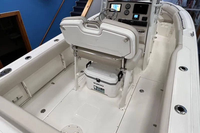 Slide: The Image of 2024 Boston Whaler 230 Outrage boat interior with helm and seating area. - 5