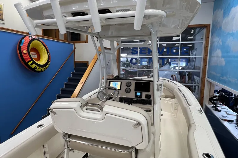 Slide: The Image of 2024 Boston Whaler 230 Outrage boat interior with helm and navigation equipment. - 6