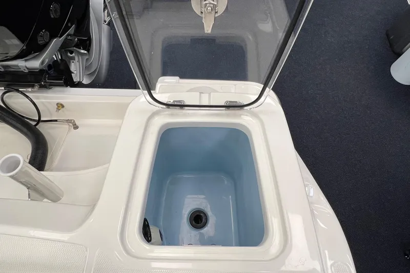 Slide: The Image of Open storage compartment on 2024 Boston Whaler 230 Outrage boat. - 9