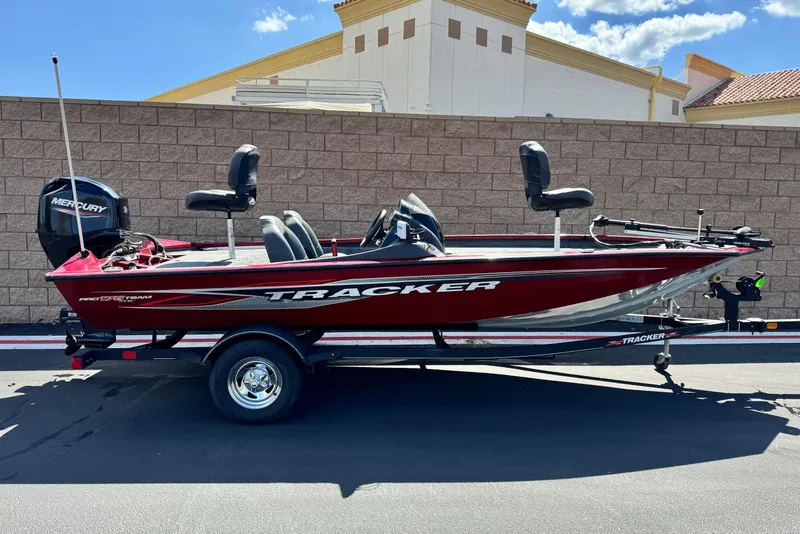 The Image of 2022 Tracker Pro Team 175 TXW boat on trailer, red color, parked outdoors. - 0