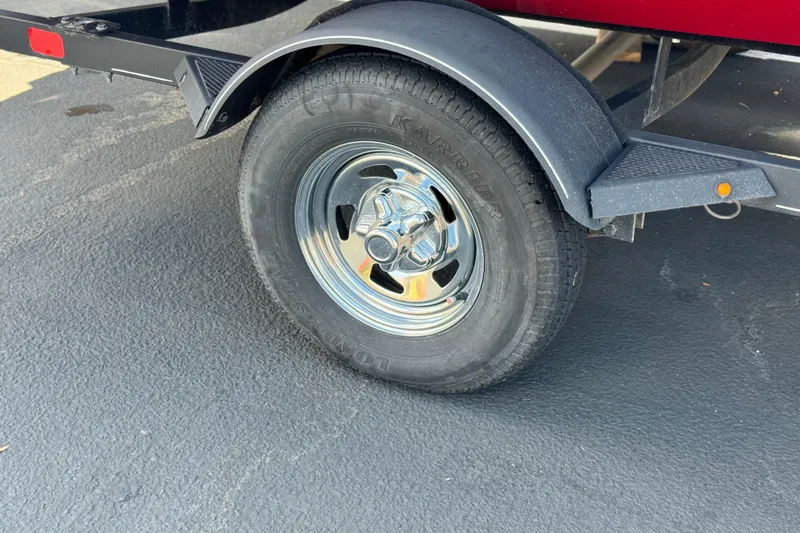 Slide: The Image of Trailer wheel of 2022 Tracker Pro Team 175 TXW boat on asphalt. - 17