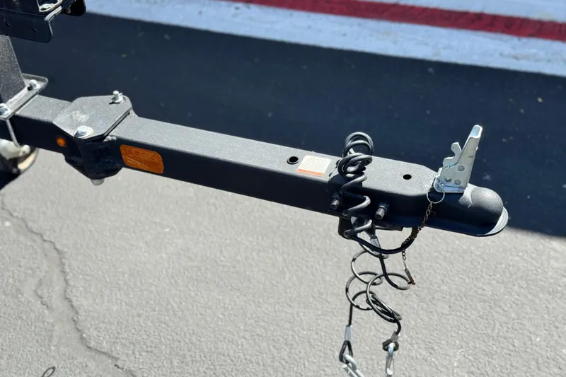 Slide: The Image of Trailer hitch of 2022 Tracker Pro Team 175 TXW on asphalt background. - 18