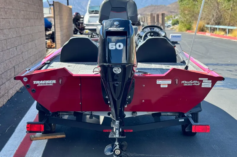Slide: The Image of 2022 Tracker Pro Team 175 TXW boat with Mercury 60 engine, parked on a road. - 4