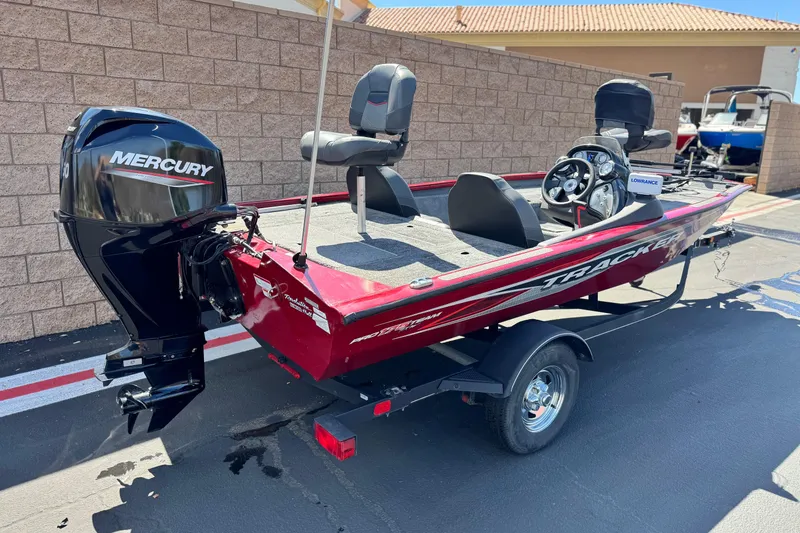Slide: The Image of 2022 Tracker Pro Team 175 TXW boat with Mercury engine, parked outdoors. - 5
