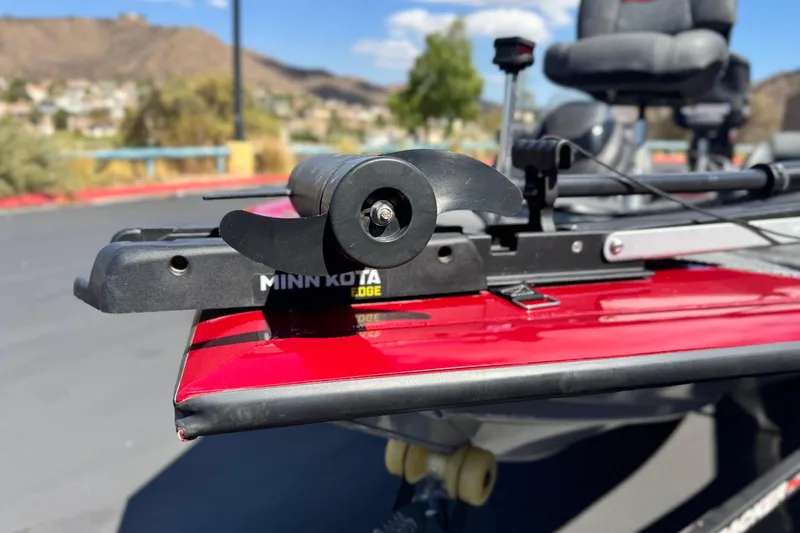 Slide: The Image of 2022 Tracker Pro Team 175 TXW with Minn Kota Edge trolling motor, red finish, outdoor setting. - 8