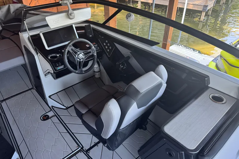 Slide: The Image of 2024 Yamaha Boats 255XE cockpit with modern steering and dashboard controls. - 7