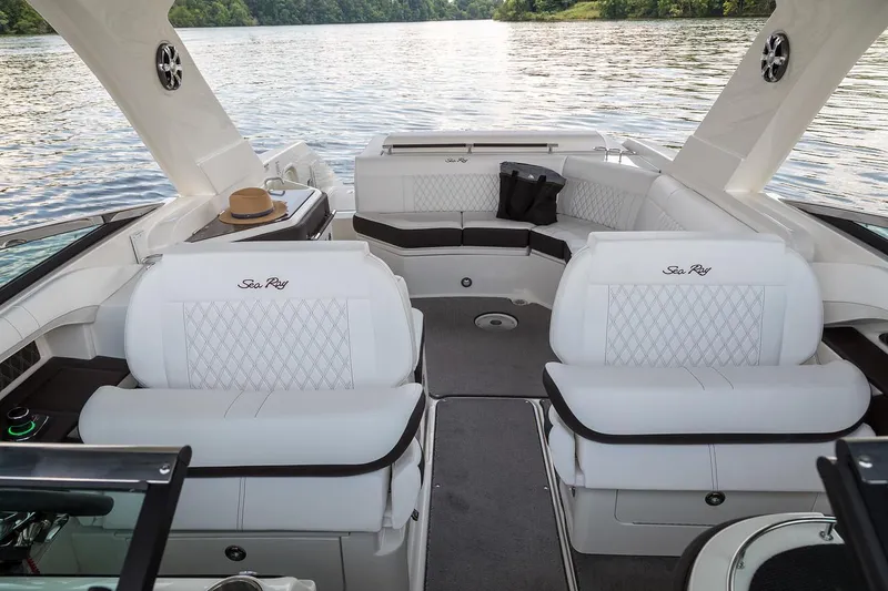 Slide: The Image of 2026 Sea Ray SLX 310 boat interior with seating and trailer in a showroom. - 5
