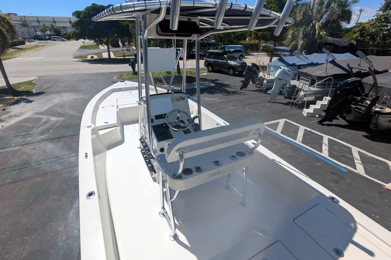 Slide: The Image of 2011 Pathfinder 2400 Tournament Edition boat with center console and T-top in a parking lot. - 10