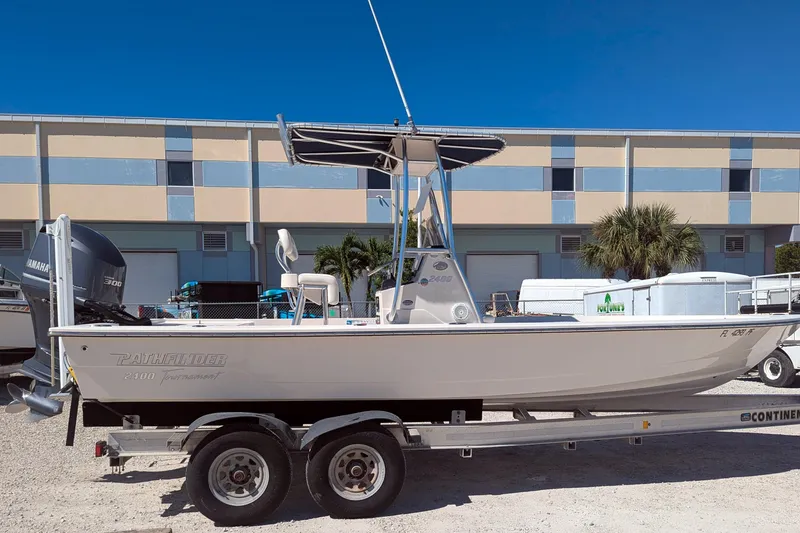 Slide: The Image of 2011 Pathfinder 2400 Tournament Edition boat on trailer, parked outdoors. - 3