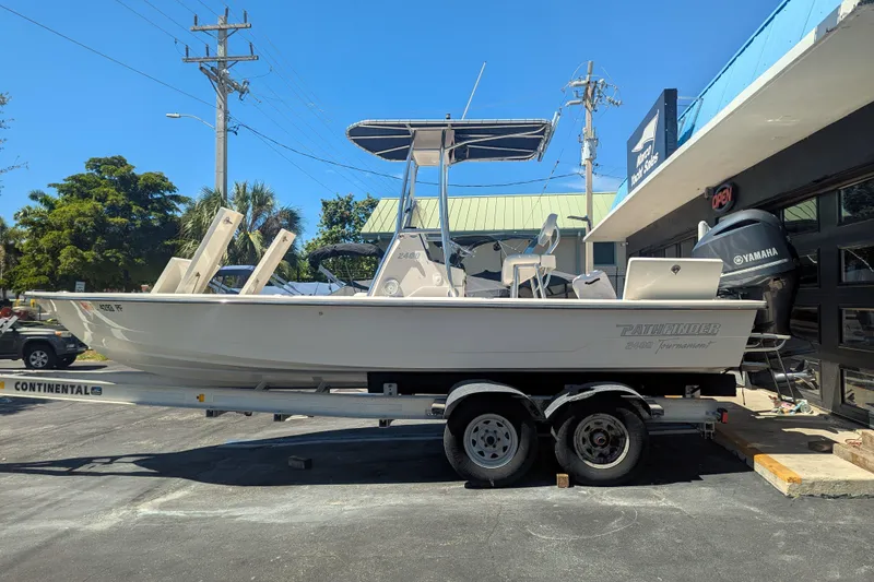 Slide: The Image of 2011 Pathfinder 2400 Tournament Edition boat on trailer, parked outside a building. - 5