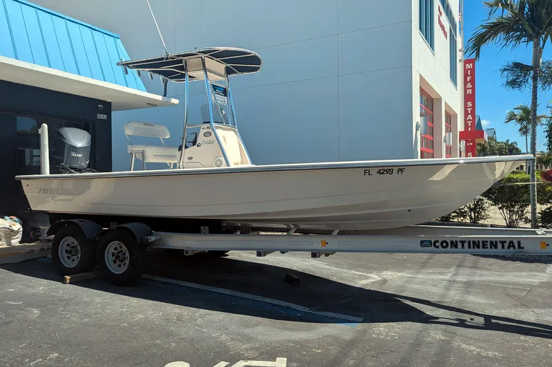 Slide: The Image of 2011 Pathfinder 2400 Tournament Edition boat on trailer outside building. - 7