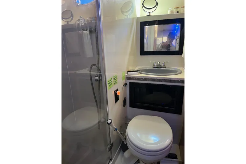 Slide: The Image of Compact bathroom in 1987 Californian 44 Veneti yacht with shower, sink, and toilet. - 17