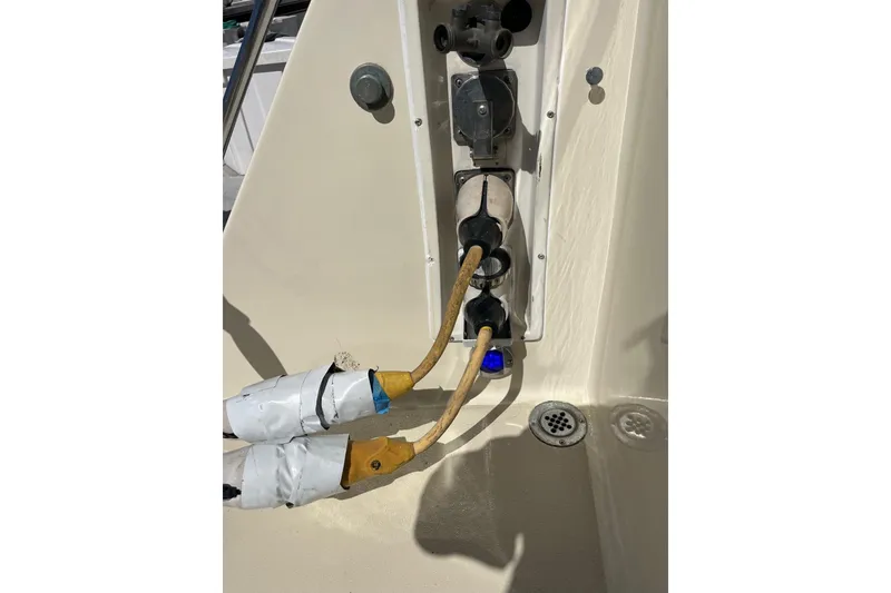 Slide: The Image of Electrical connections on a 1987 Californian 44 Veneti boat, featuring taped cables and outlets. - 25