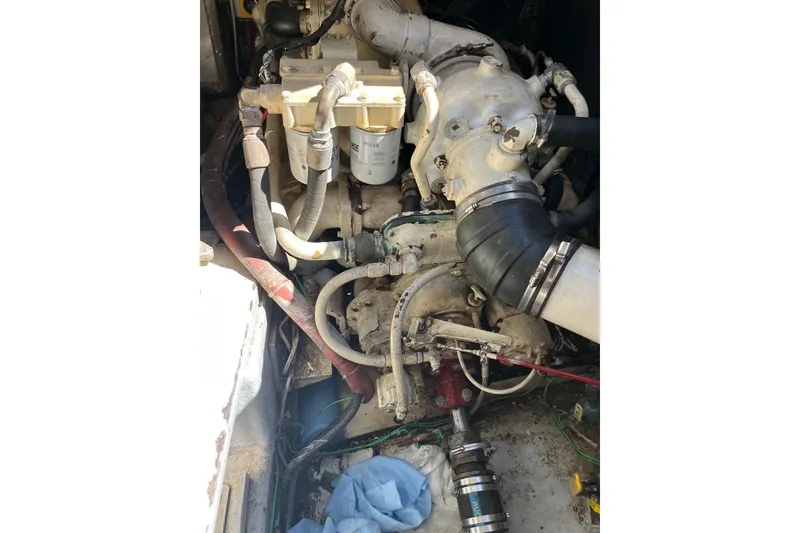 Slide: The Image of Engine compartment of a 1987 Californian 44 Veneti boat, showing hoses and components. - 26