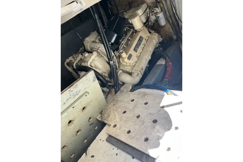 Slide: The Image of Engine compartment of a 1987 Californian 44 Veneti boat, featuring a detailed engine view. - 27
