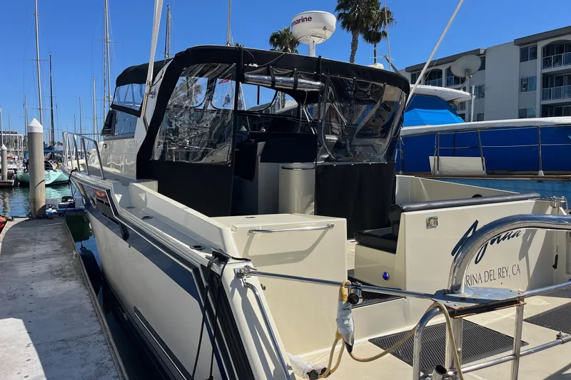 Slide: The Image of 1987 Californian 44 Veneti yacht docked at Marina del Rey, featuring sleek design and covered deck. - 3