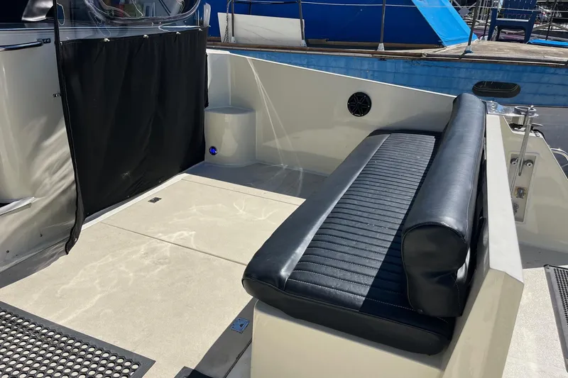 Slide: The Image of 1987 Californian 44 Veneti boat interior with black seating and deck area. - 9