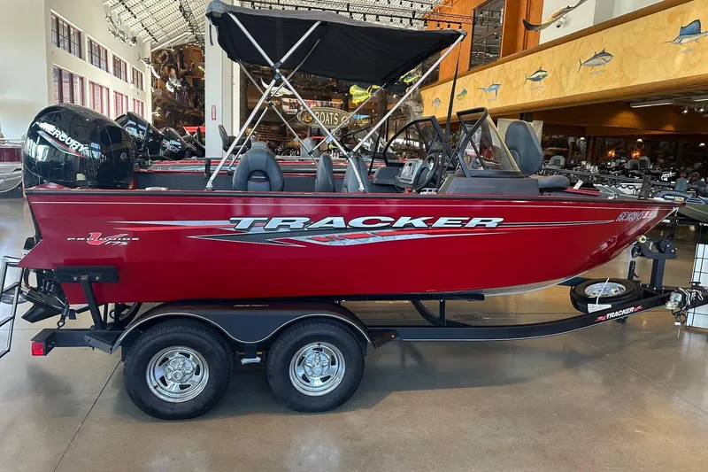 Slide: The Image of 2023 Tracker Pro Deep V-17 boat in showroom, red exterior, on trailer. - 3