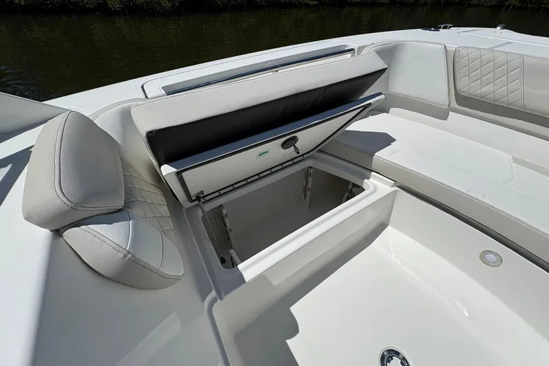 Slide: The Image of 2026 World Cat 296 DC boat with open storage compartment and cushioned seating. - 18