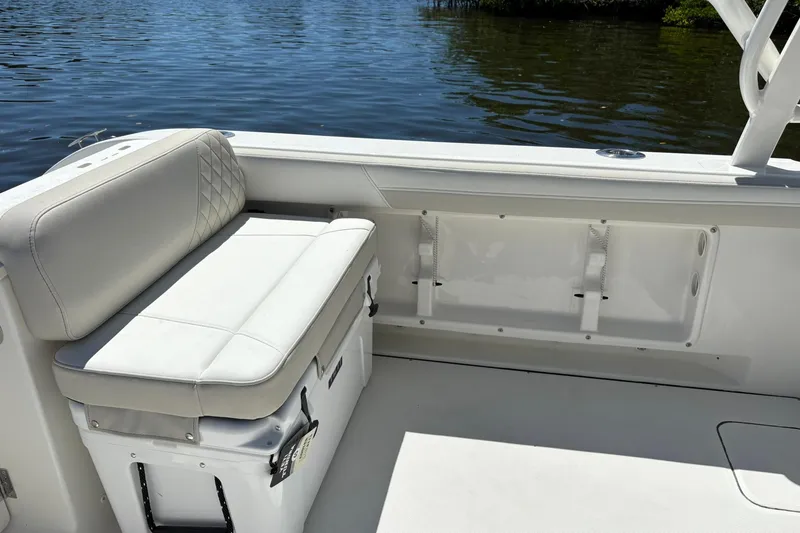 Slide: The Image of 2026 World Cat 296 DC boat interior with cushioned seating by the water. - 6