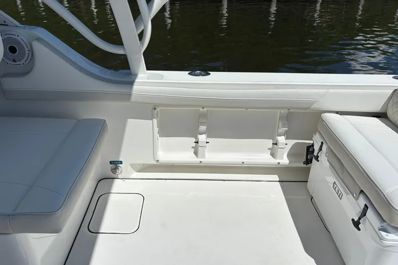 Slide: The Image of Interior of 2026 World Cat 296 DC boat with white seating and storage. - 7