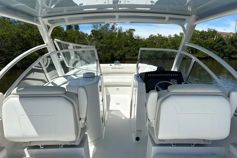 Slide: The Image of 2026 World Cat 296 DC boat interior with dual consoles and white seating. - 8