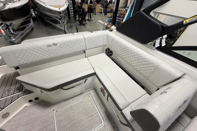 Slide: The Image of 2026 Sea Ray SDX 230 boat interior with white cushioned seating and elegant design. - 13