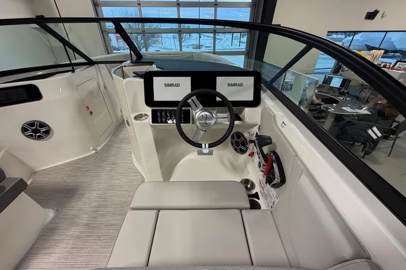Slide: The Image of 2026 Sea Ray SDX 230 boat cockpit with Simrad navigation system and modern steering wheel. - 16